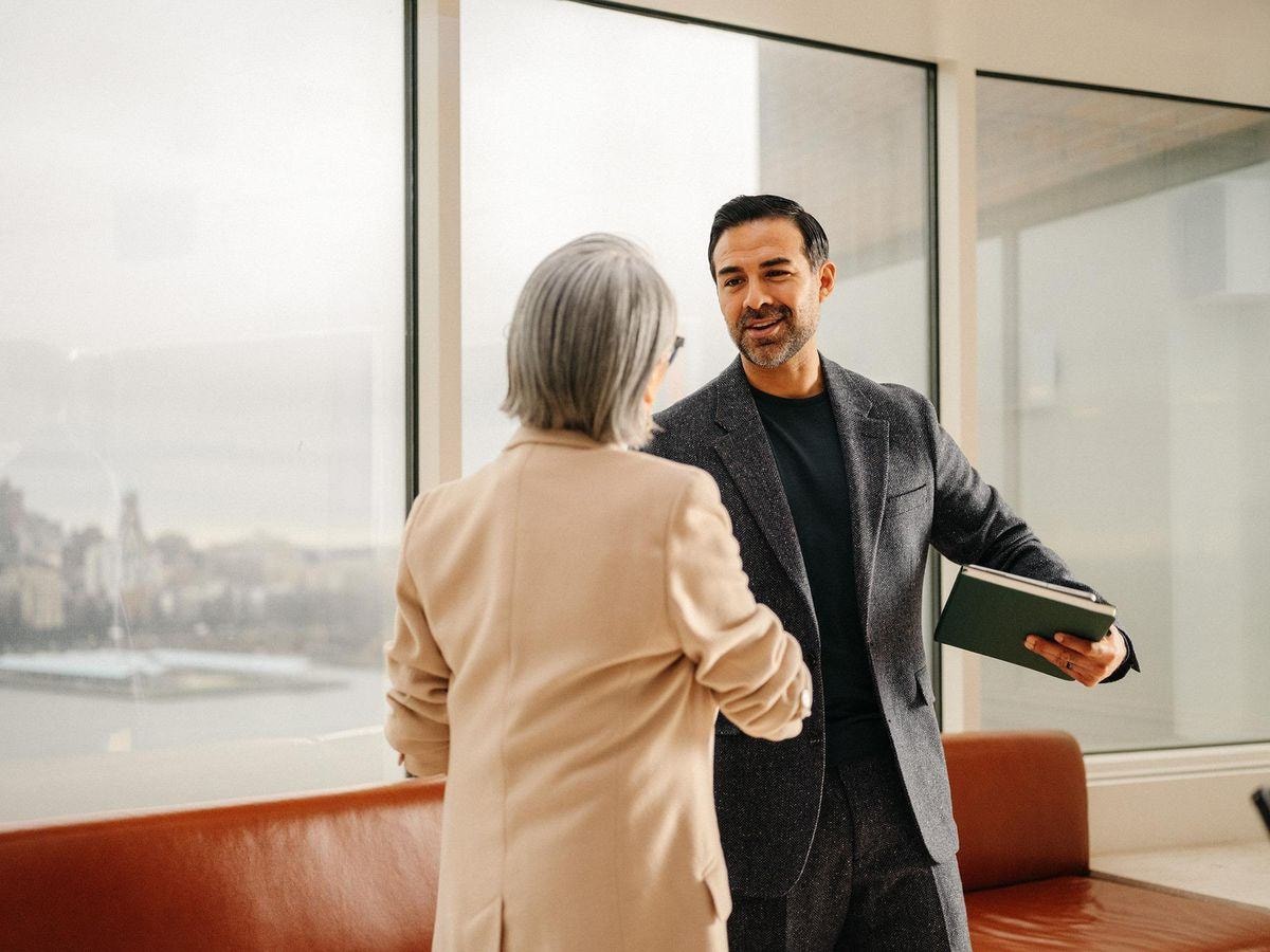 A LINK adviser greeting a client