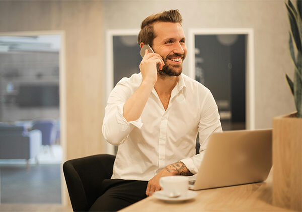 man-on-phone-working-laptop-img